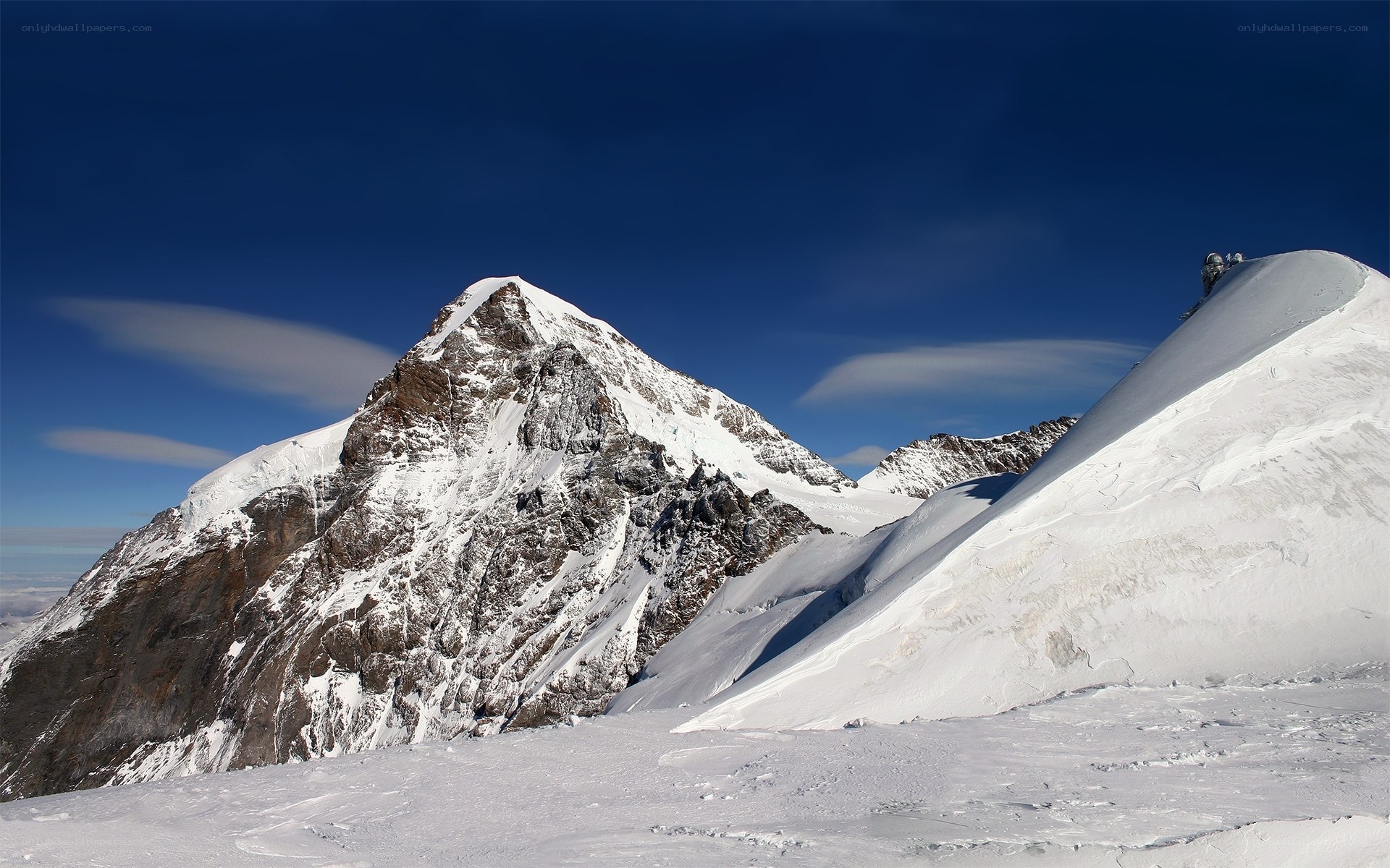 Snowy mountain peak under blue sky