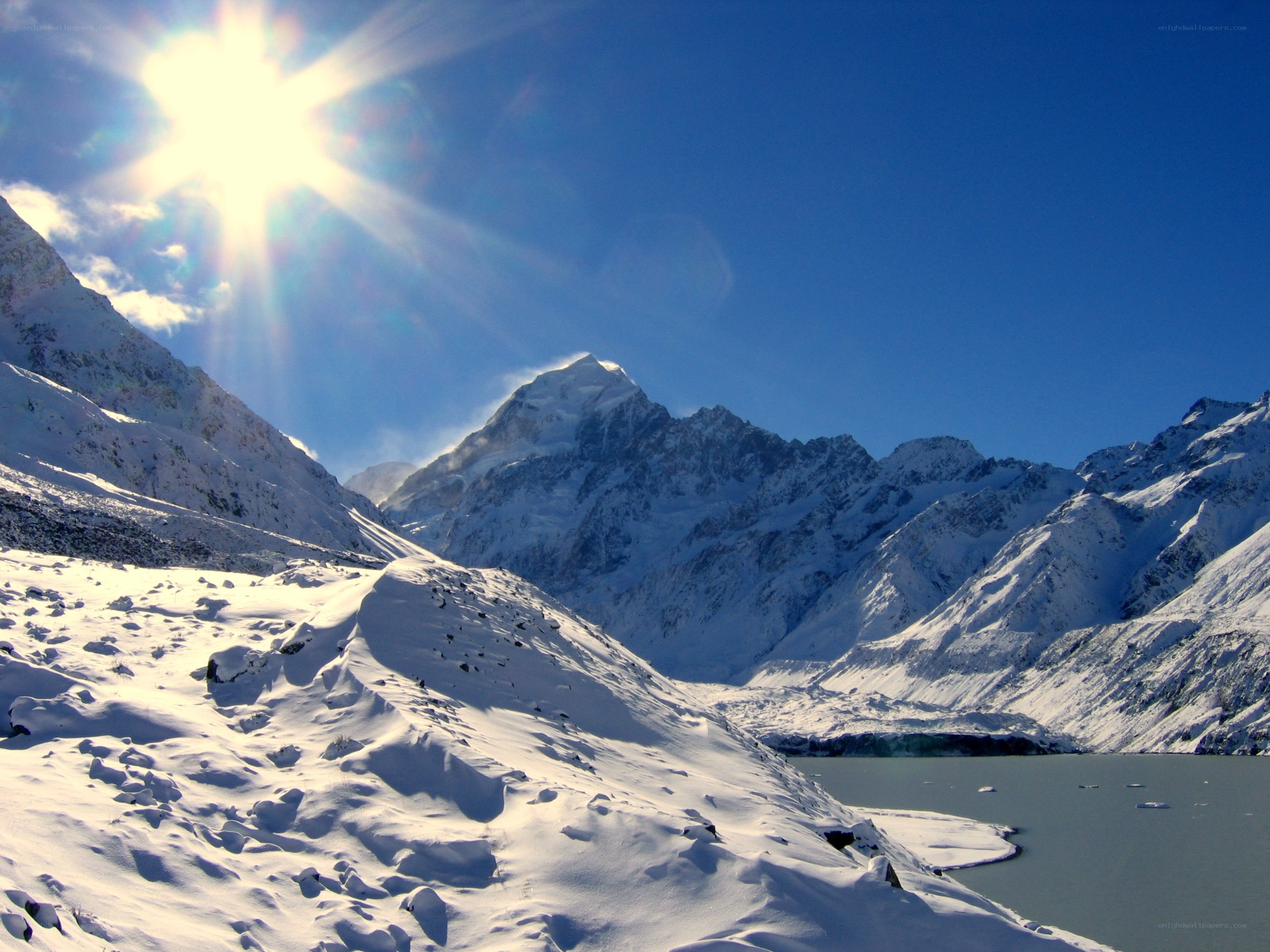 Snowy mountain peak under sun