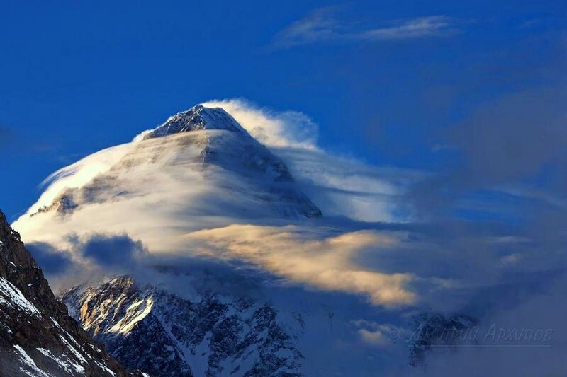 Snowy mountain peak with clouds