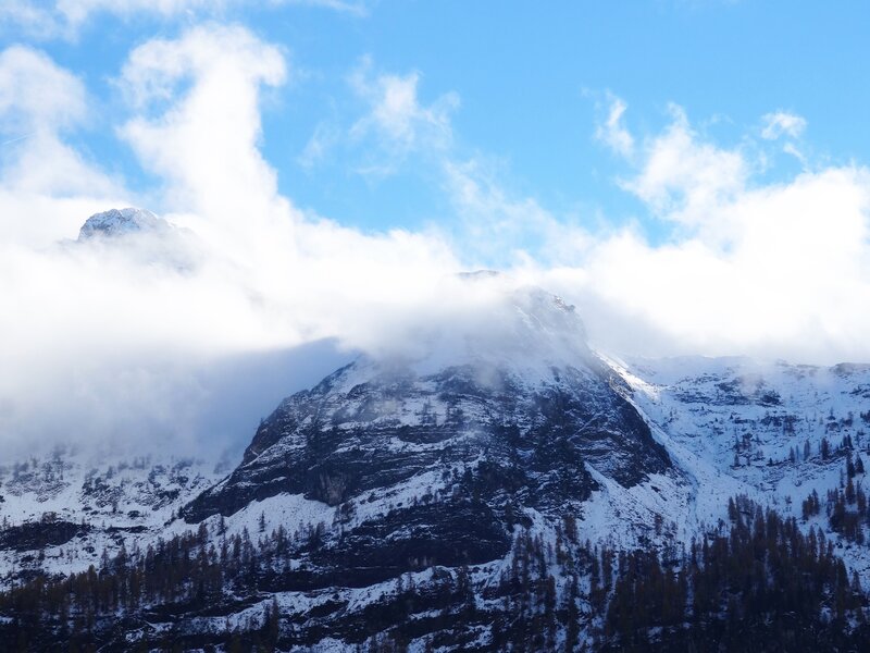 Snowy mountain peak with clouds