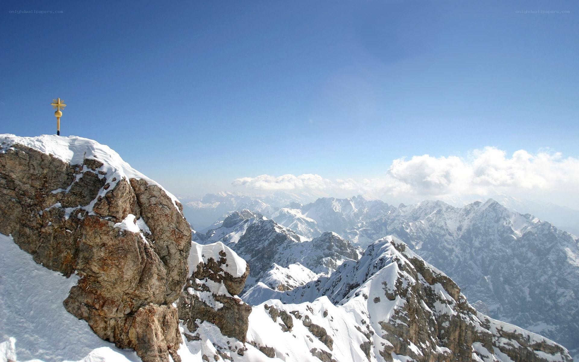 Snowy mountain peak with cross