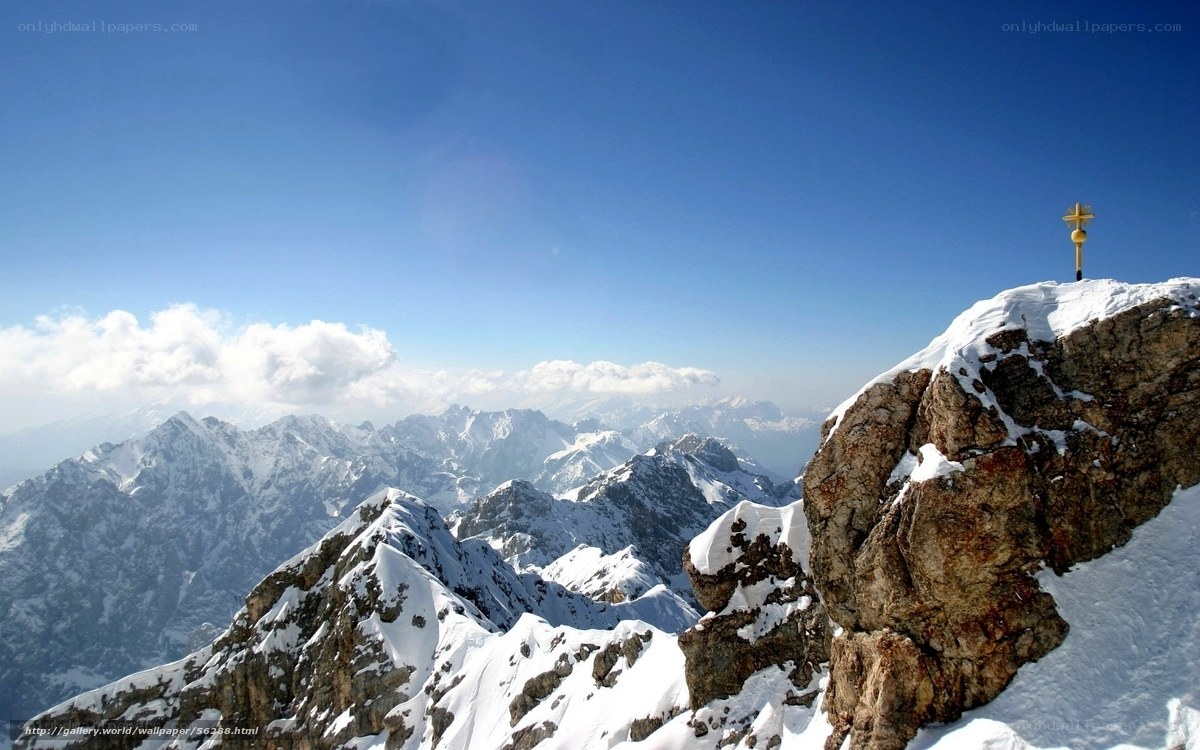 Snowy mountain peak with cross
