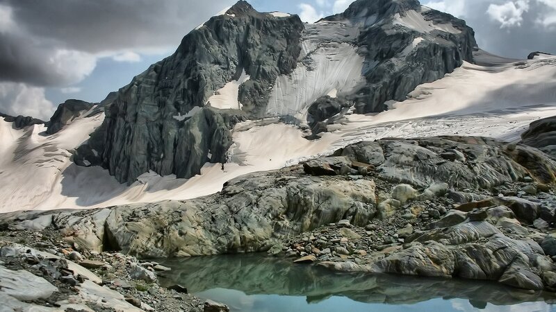 Snowy mountain peak with lake