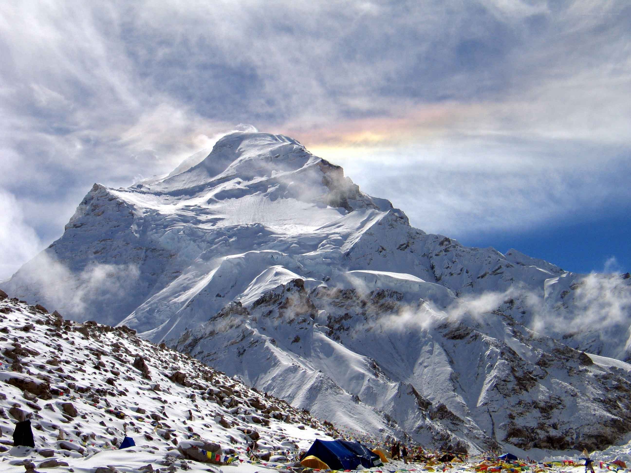 Snowy mountain peak with prayer flags