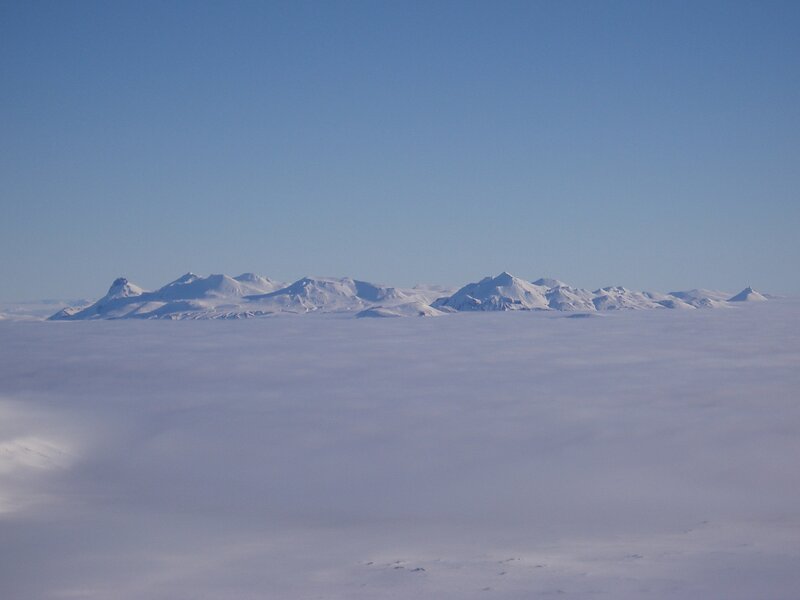Snowy mountain peaks above clouds