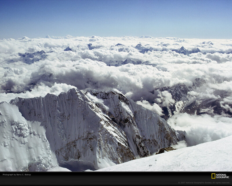 Snowy mountain peaks above clouds