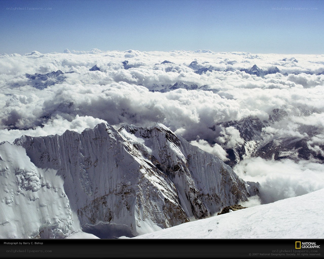 Snowy mountain peaks above clouds