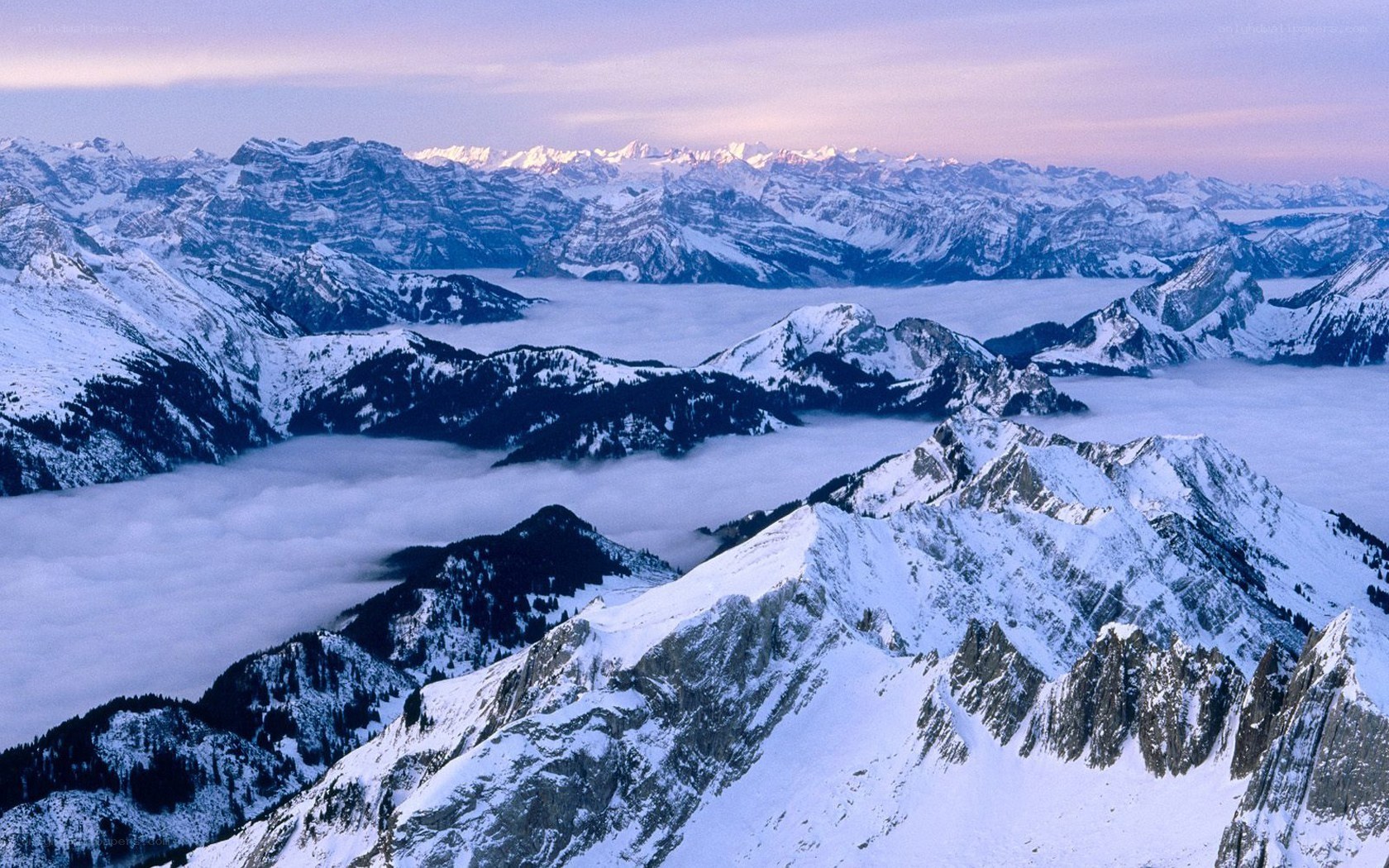 Snowy mountain peaks above clouds