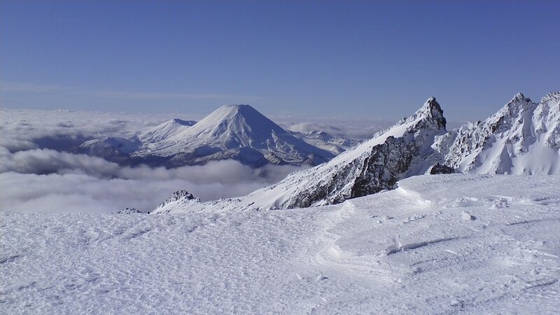 Snowy mountain peaks above clouds