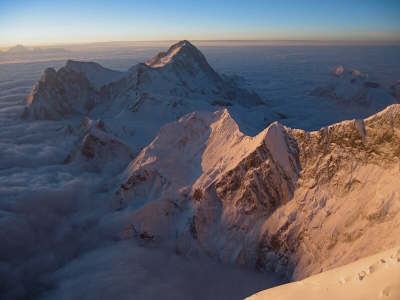 Snowy mountain peaks above clouds