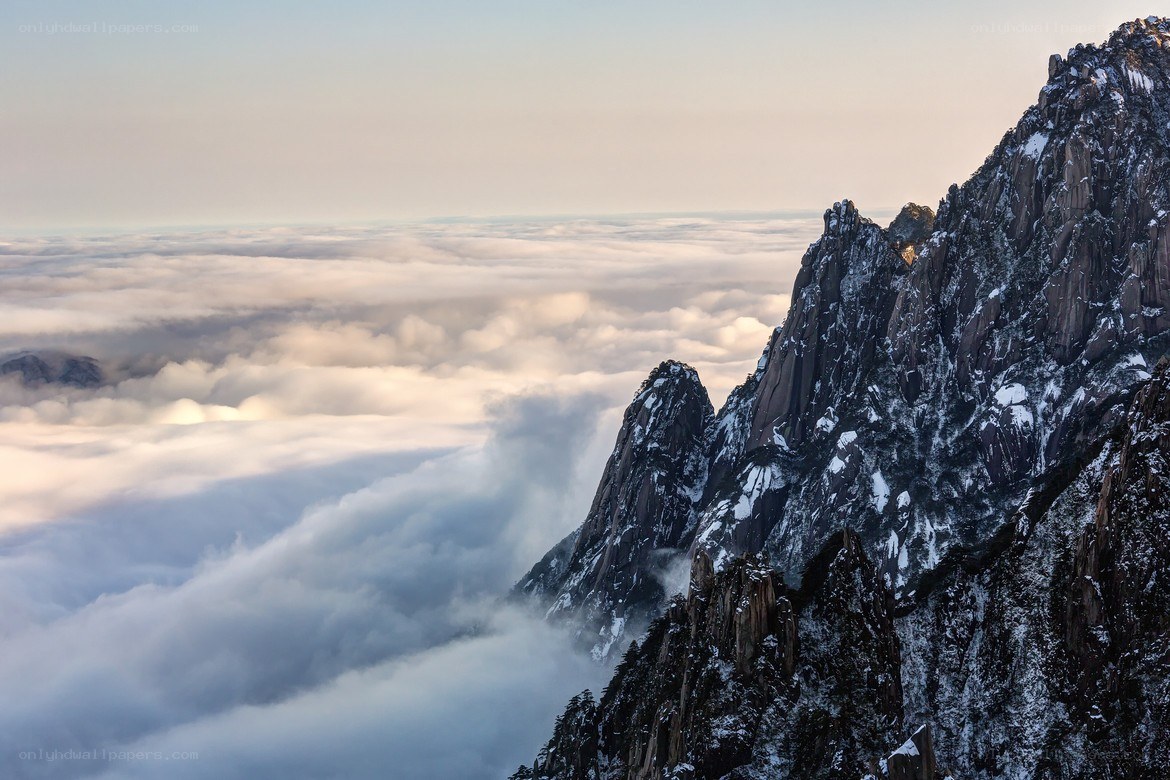 Snowy mountain peaks above clouds