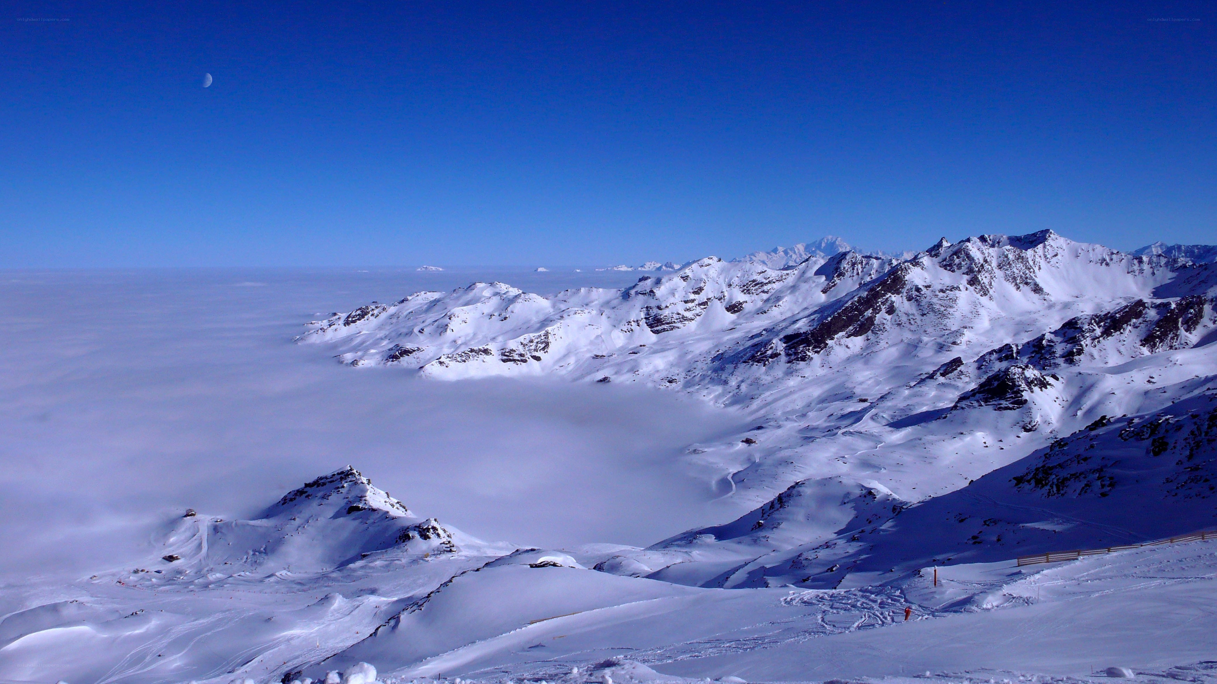 snowy mountain peaks above clouds