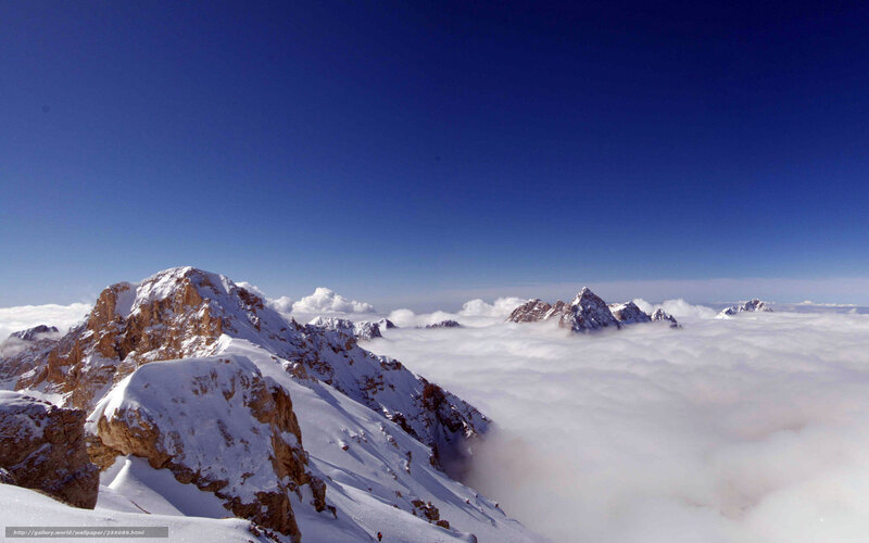 Snowy mountain peaks above clouds
