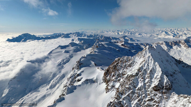 snowy mountain peaks above clouds