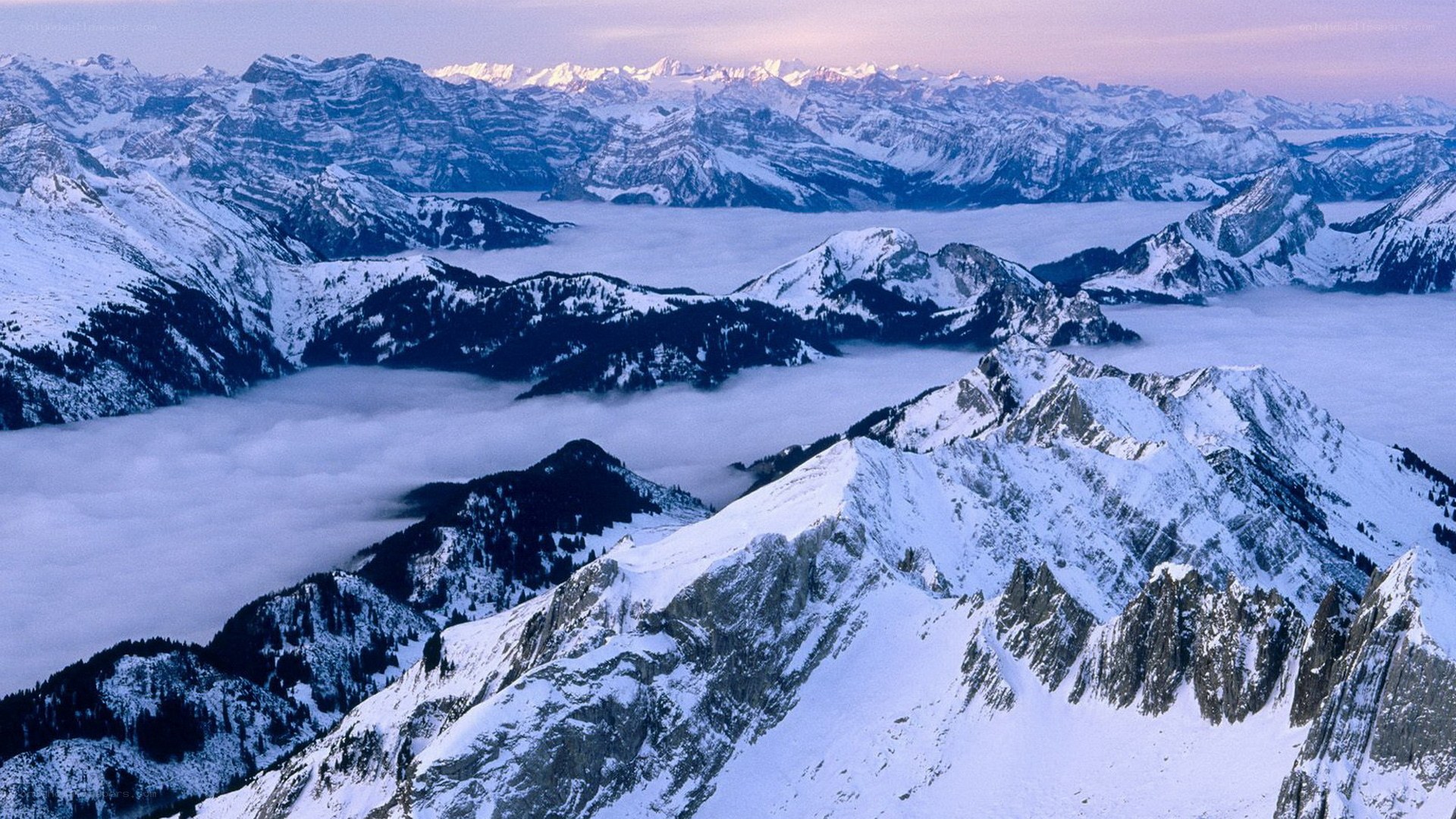 Snowy mountain peaks above clouds