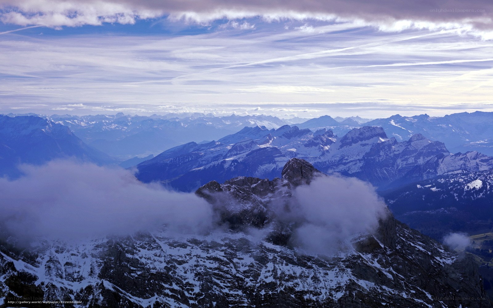 Snowy mountain peaks and clouds