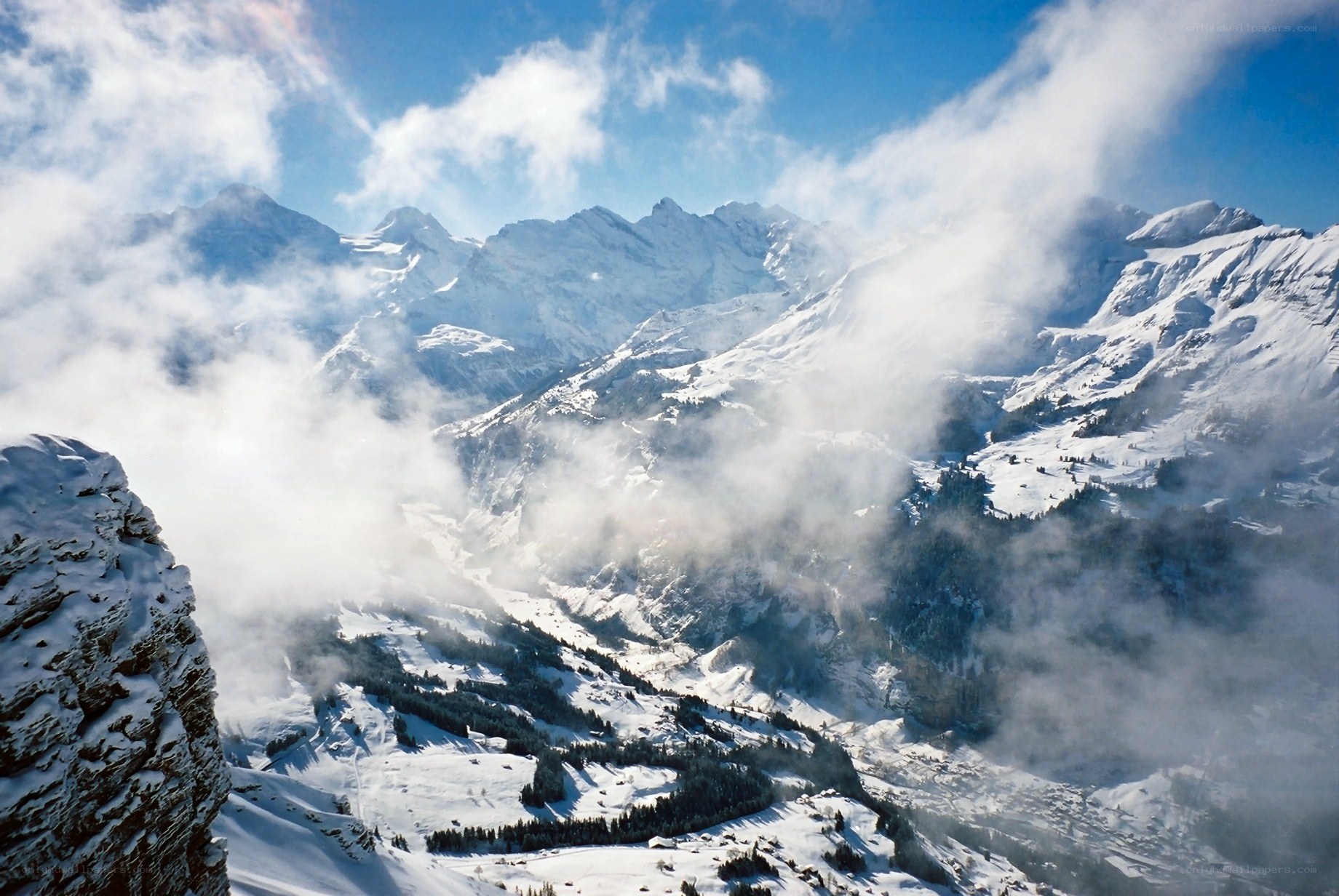 snowy mountain peaks and clouds