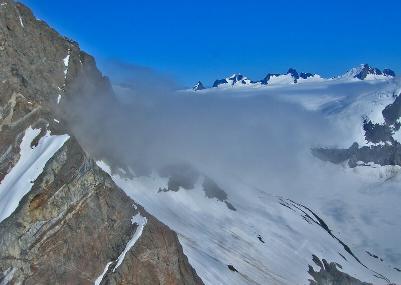 Snowy mountain peaks and clouds