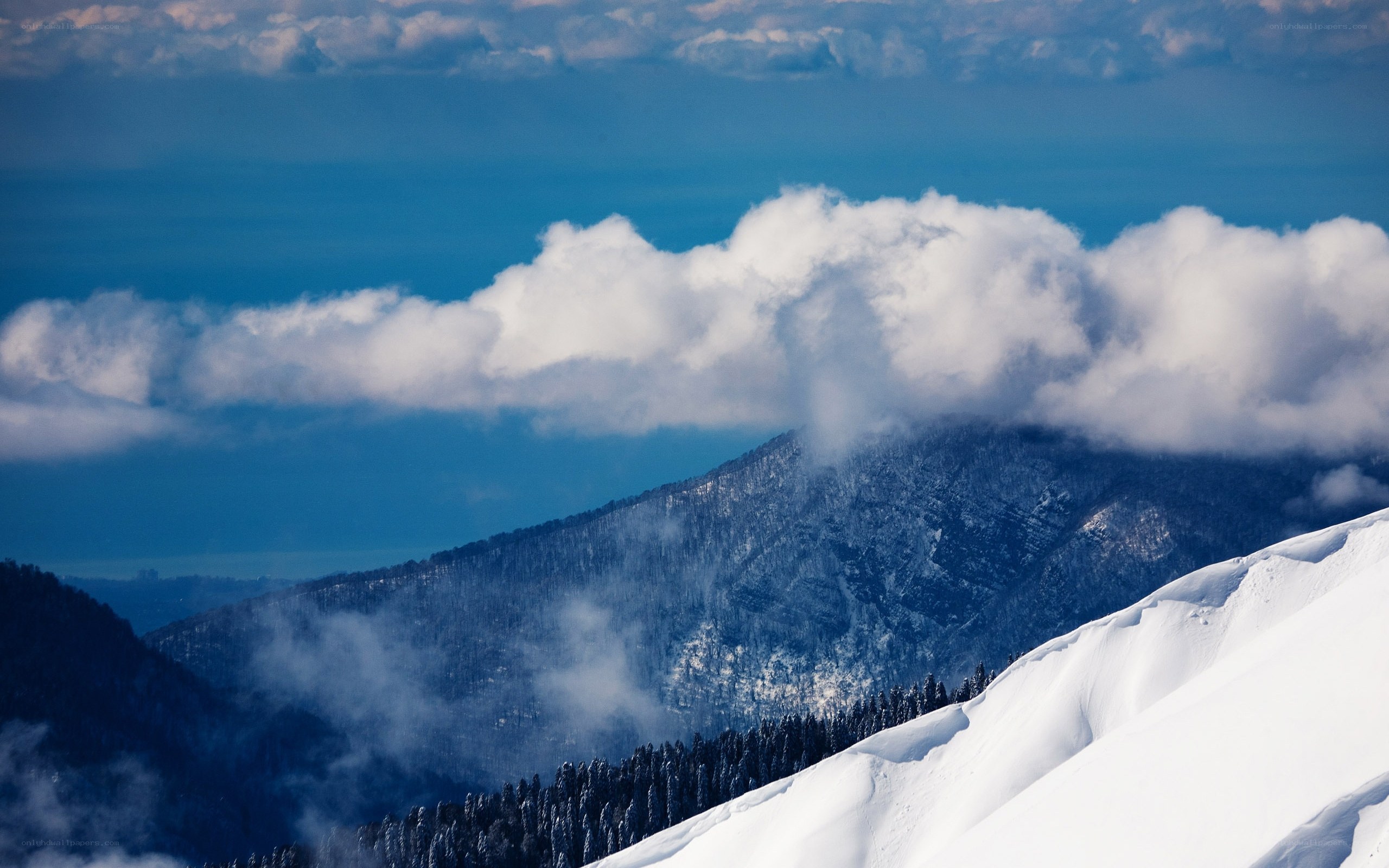 Snowy mountain peaks and clouds