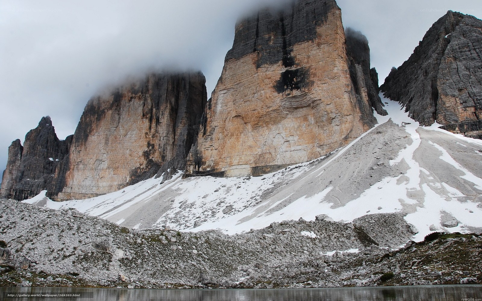 Snowy mountain peaks and lake