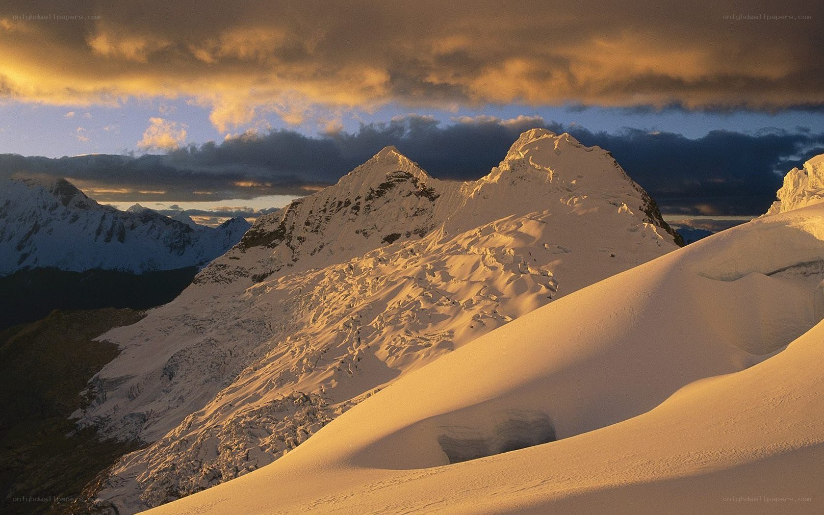 Snowy mountain peaks at sunset