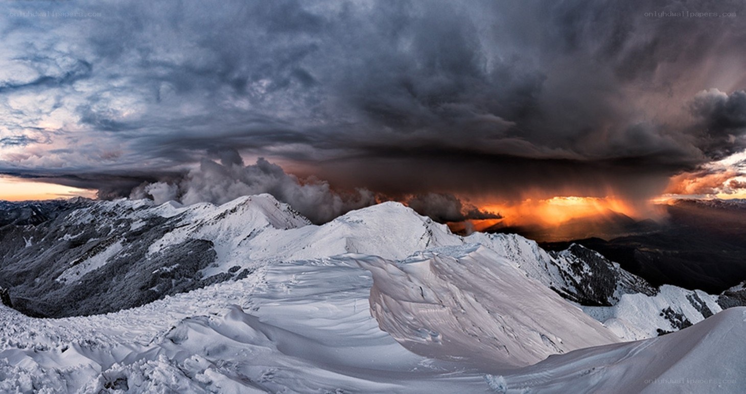 Snowy mountain peaks at sunset