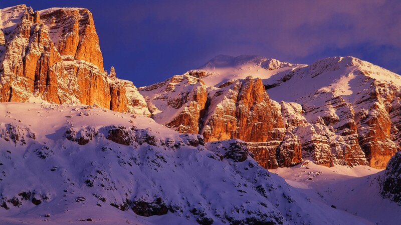 Snowy mountain peaks at sunset
