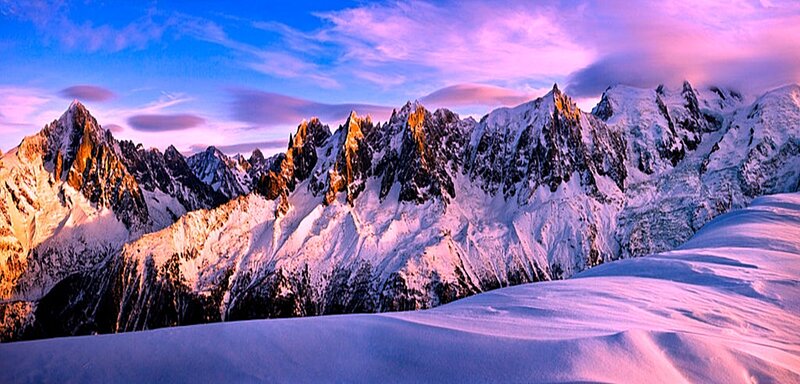 Snowy mountain peaks at sunset