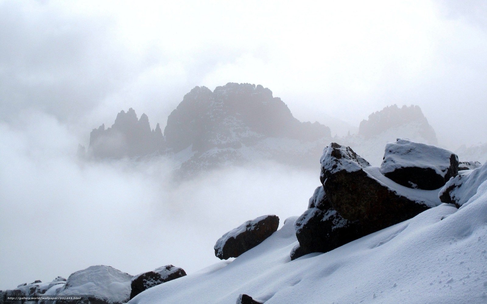 Snowy mountain peaks in fog