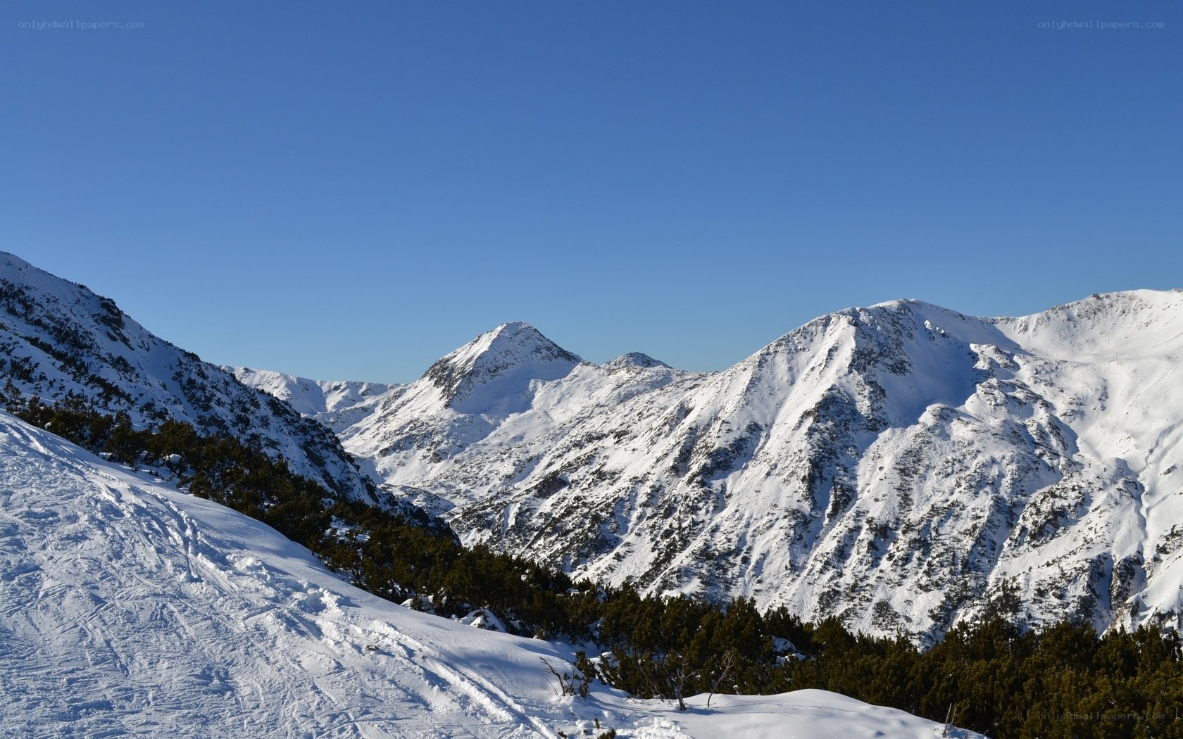 Snowy mountain peaks under blue sky