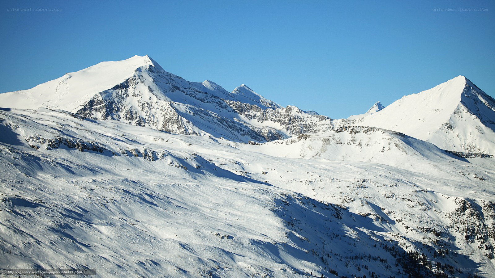 Snowy mountain peaks under blue sky