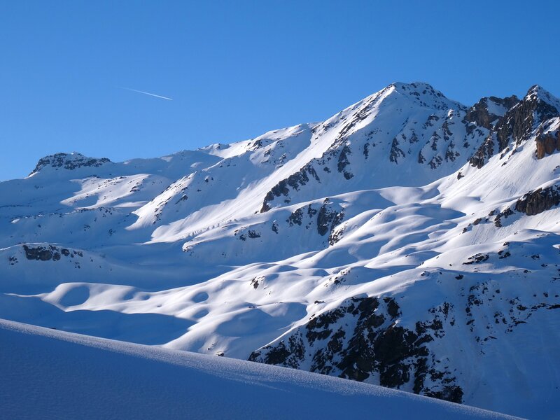 Snowy mountain peaks under blue sky