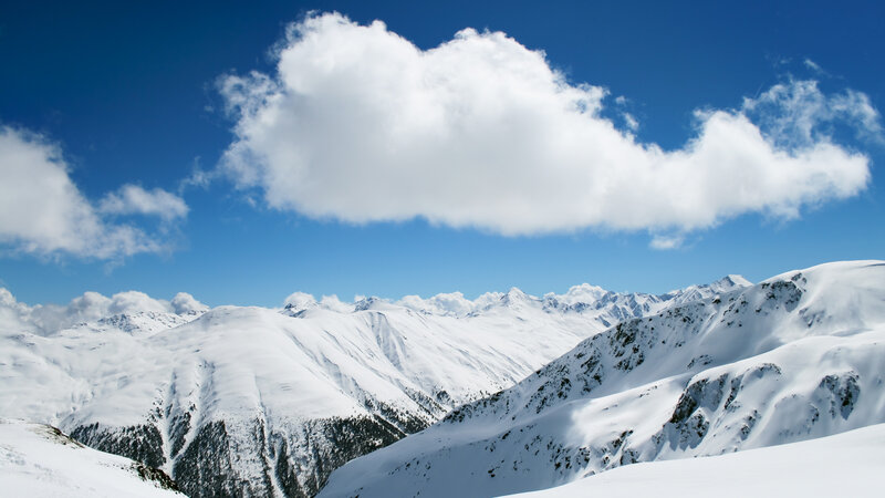Snowy mountain peaks under blue sky