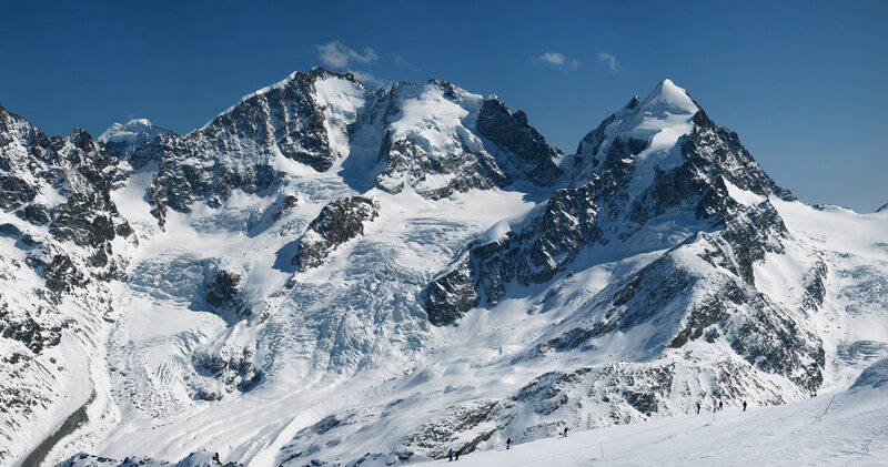 snowy mountain peaks under blue sky