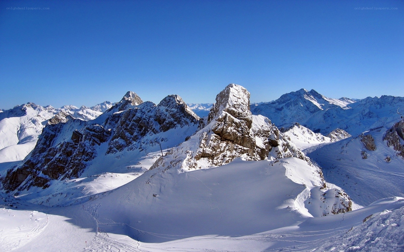 snowy mountain peaks under blue sky