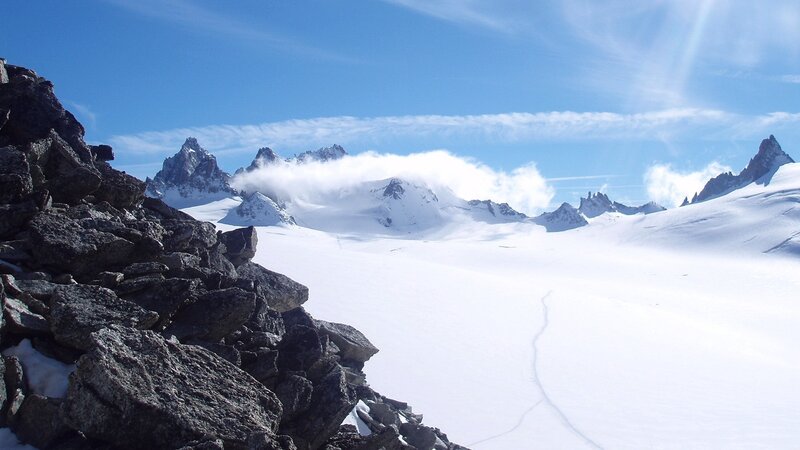 snowy mountain peaks under blue sky