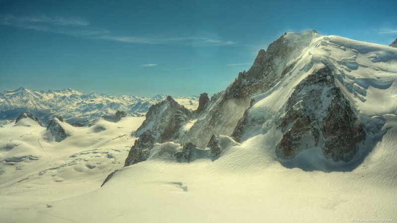 snowy mountain peaks under blue sky