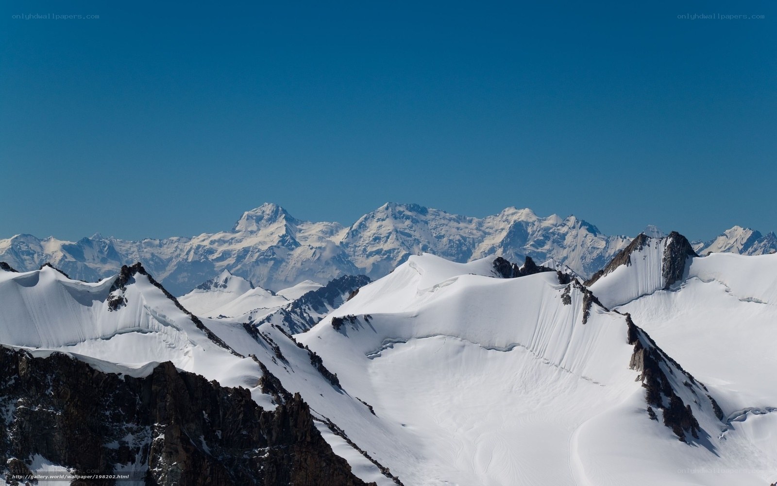 Snowy mountain peaks under blue sky