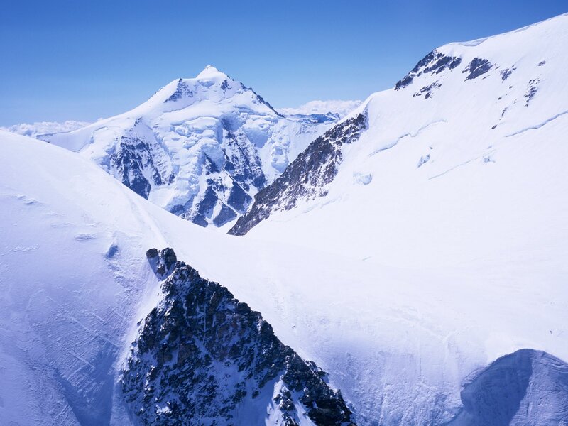 Snowy mountain peaks under blue sky