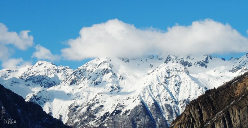 snowy mountain peaks under blue sky