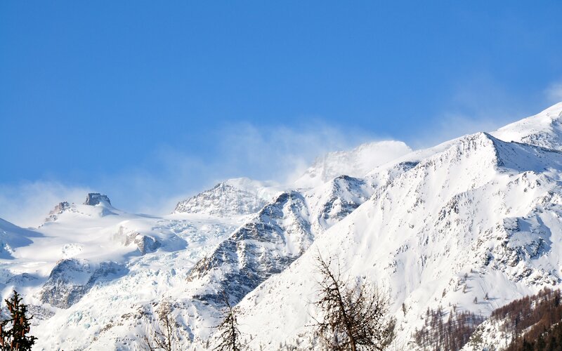 Snowy mountain peaks under blue sky