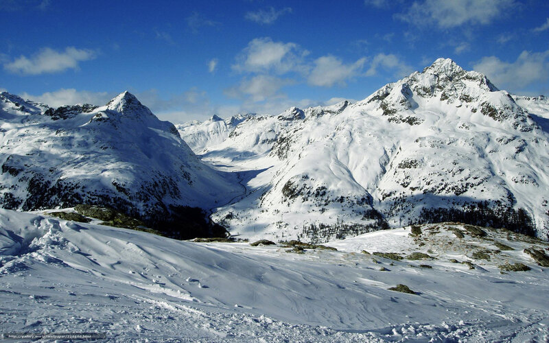 snowy mountain peaks under blue sky
