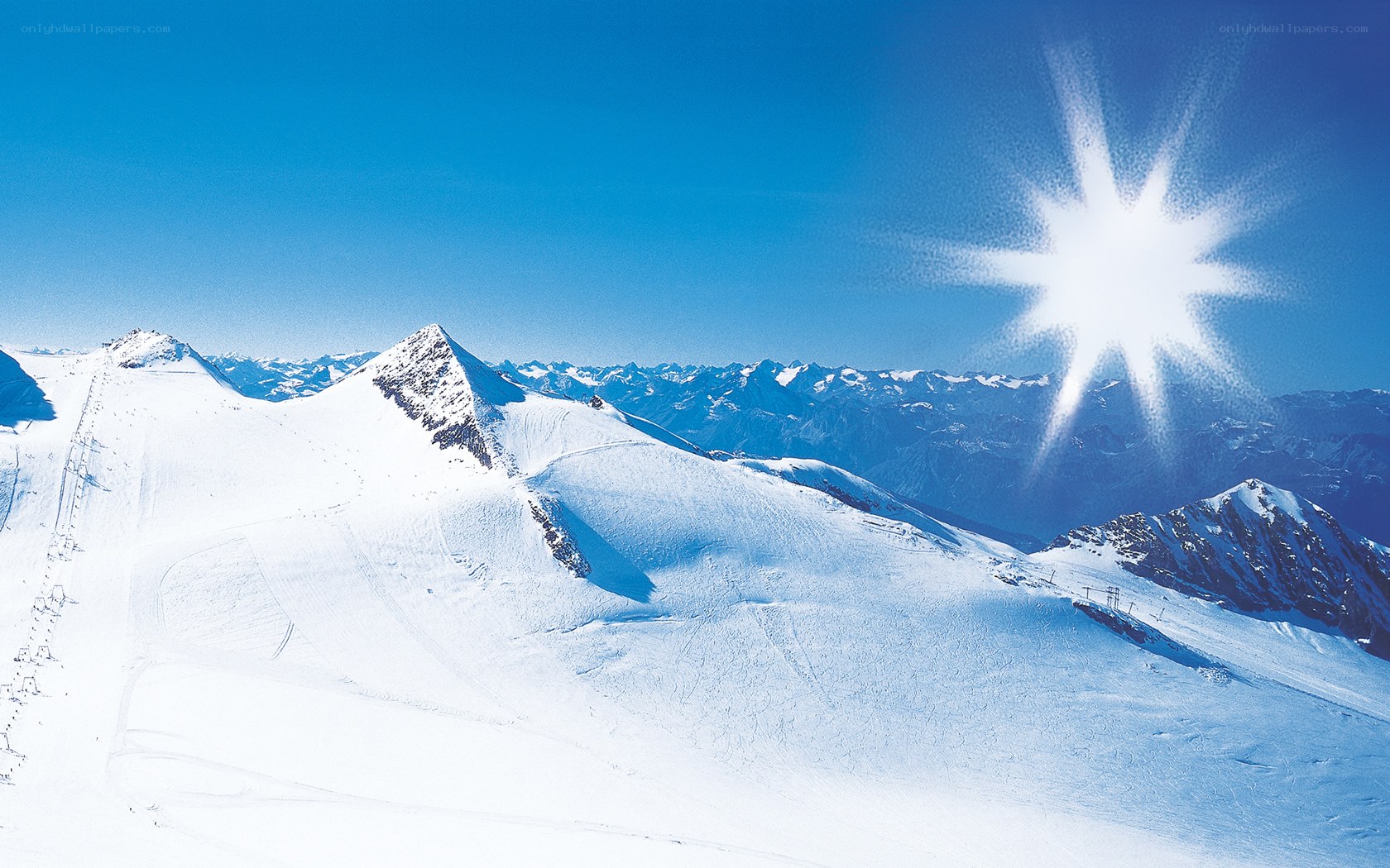 Snowy mountain peaks under bright sun