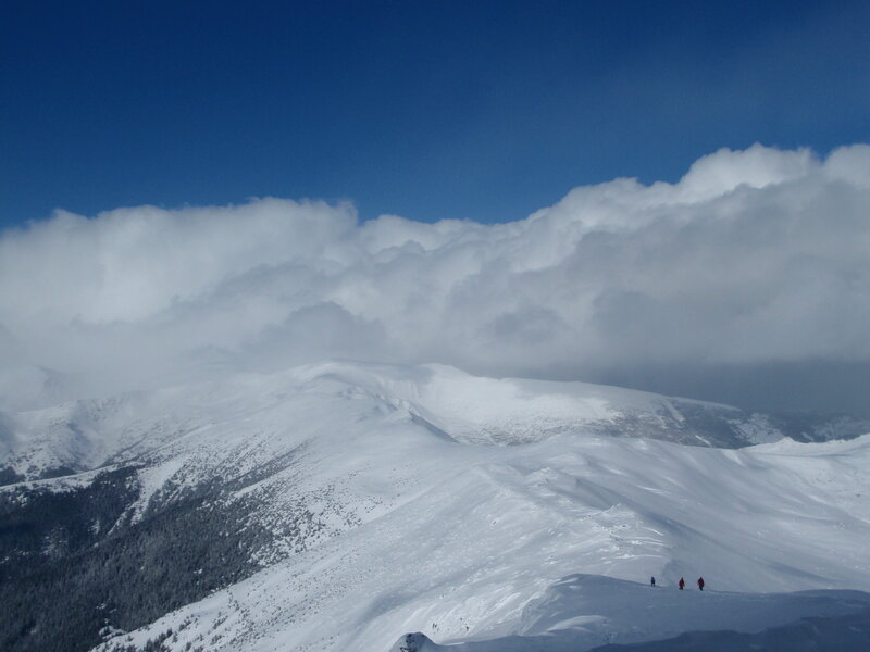 Snowy mountain peaks under clouds