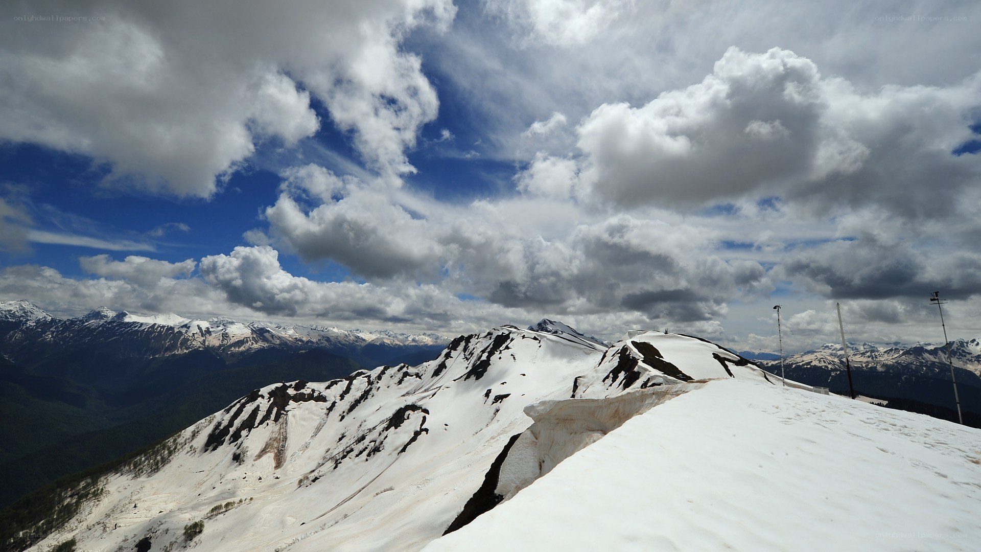 snowy mountain peaks under cloudy sky