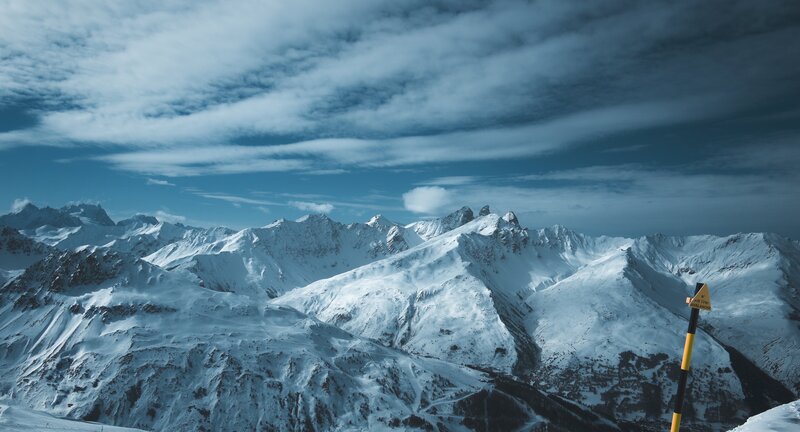 snowy mountain peaks under cloudy sky