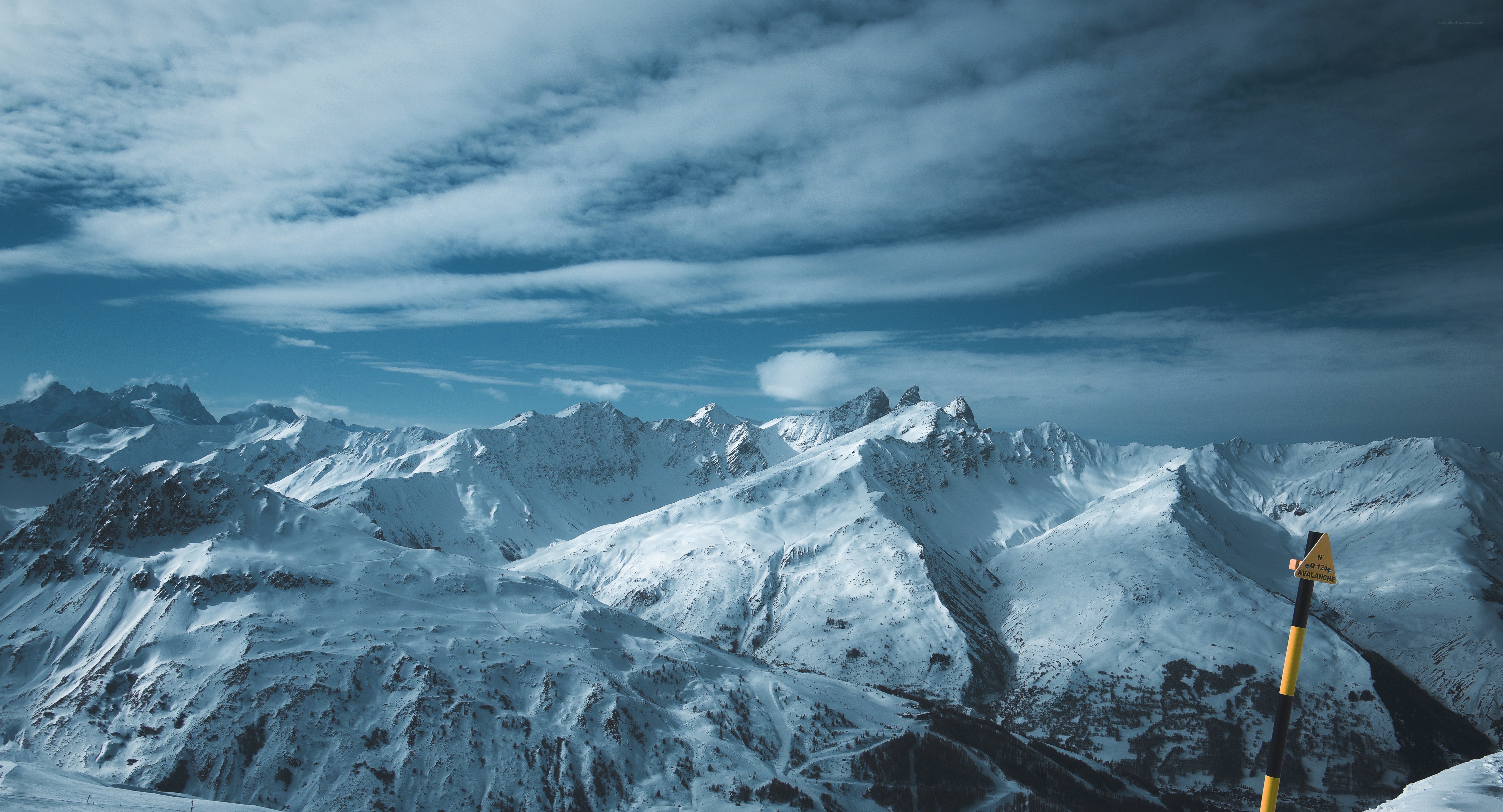 snowy mountain peaks under cloudy sky