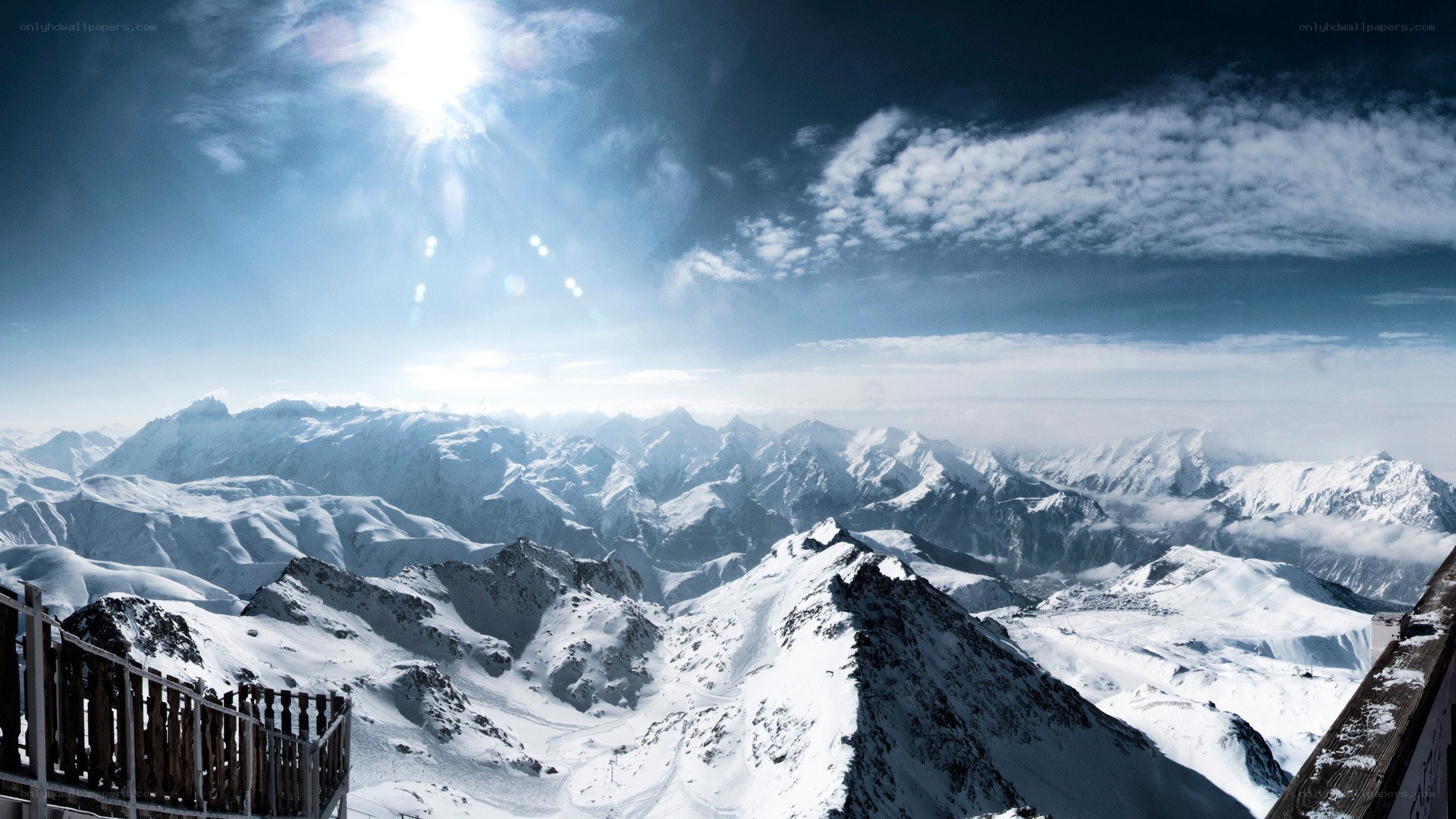Snowy mountain peaks under sun