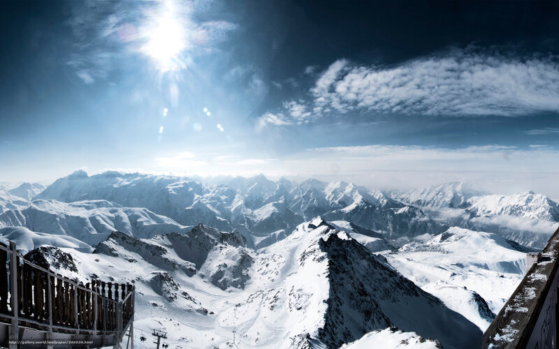 Snowy mountain peaks under sun