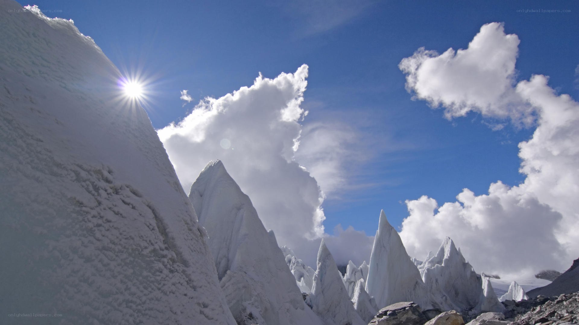 Snowy mountain peaks under sun